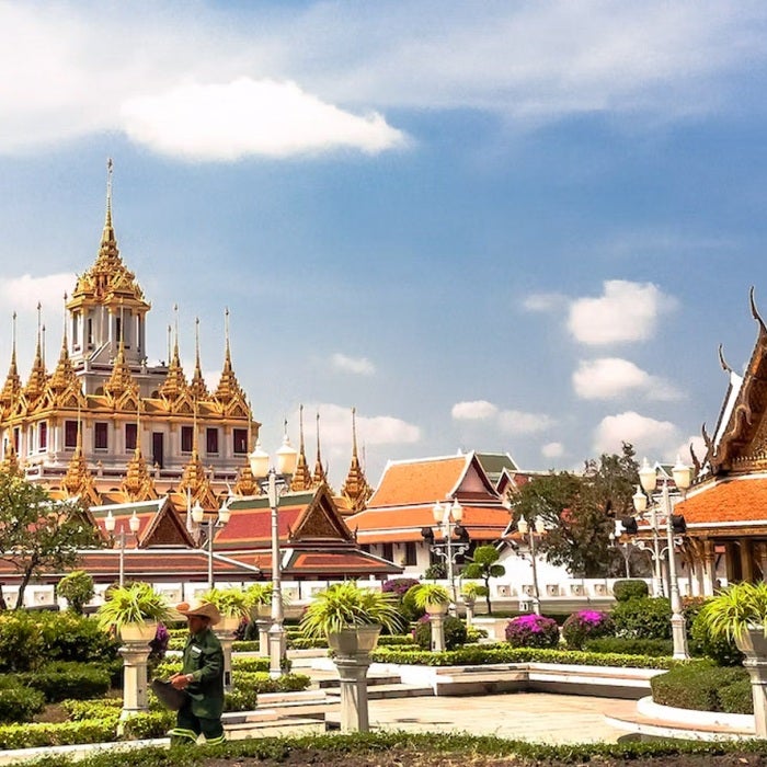 Temples in Bangkok, Thailand against a beautiful blue sky and puffy white clouds day