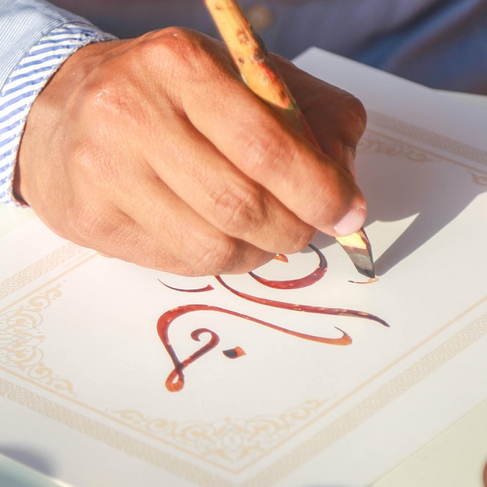 An Arabic calligrapher practices his craft