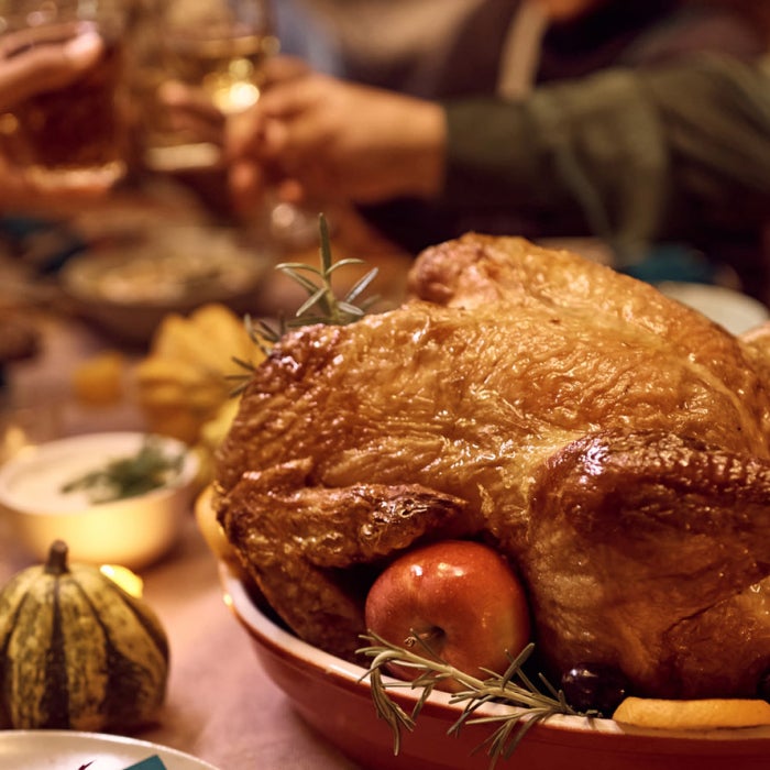 Friends gather around a thanksgiving feast to enjoy good food and good company