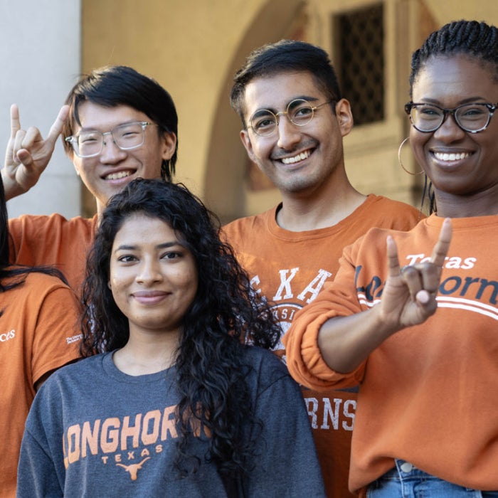 Smiling UT students show off their longhorn pride