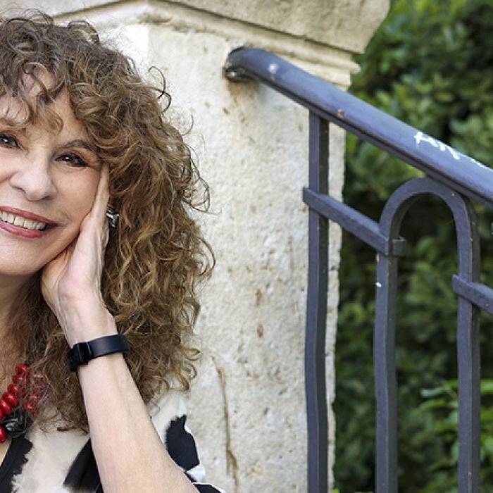 Nicaraguan writer and political dissident Gioconda Belli sits on stone steps