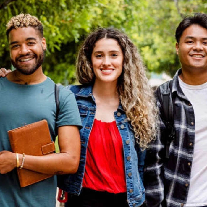 Five students posing on a campus