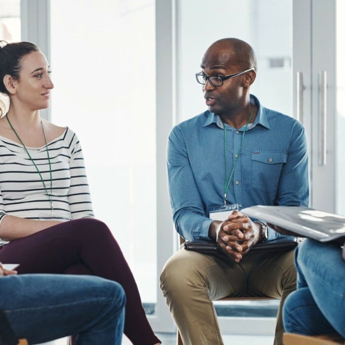 A small group of people sitting in a circle and participating in group therapy