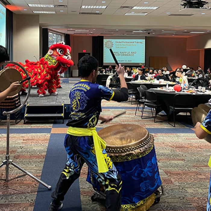 Performers from the Texas Southern Sea Dragon and Lion Dance Association danced onstage and moved from table to table, allowing students and guests to pet the giant “animals” costumed in red fringe.