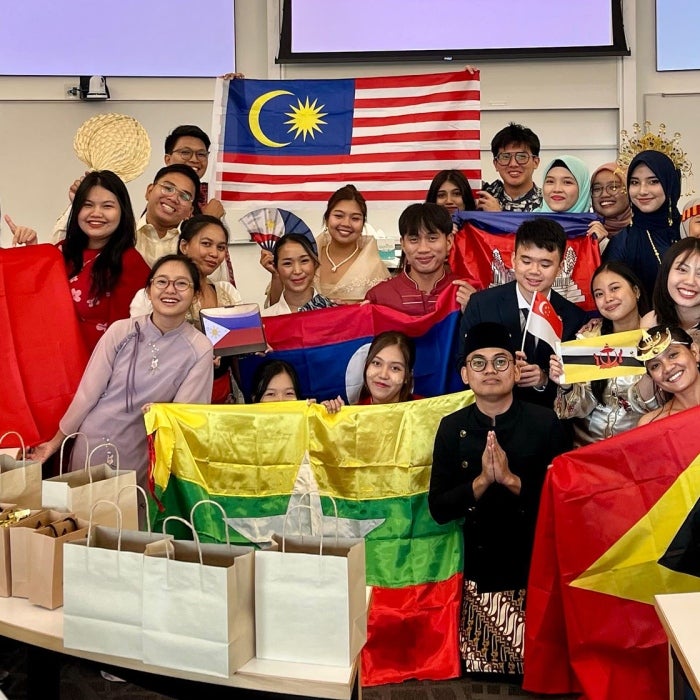 YSEALI cultural presentations, group poses with flags of different countries