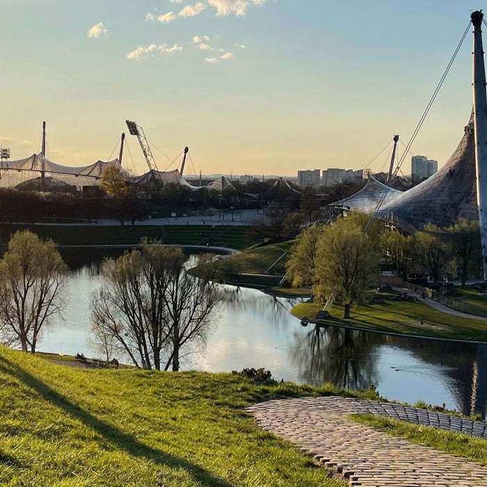 students enjoy the late day sun on the grass
