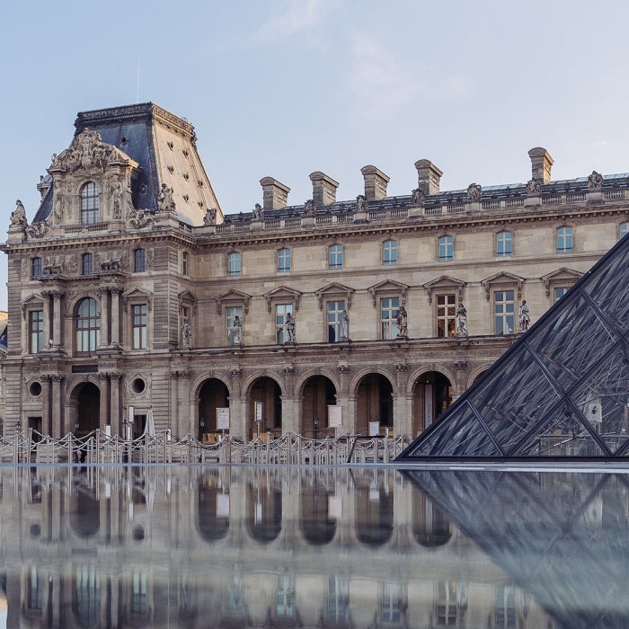 Photo of the exterior of the famous Louvre Museum in France