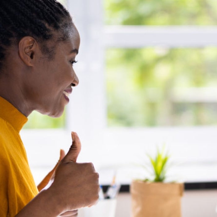 Girl giving thumbs up on a virtual meeting