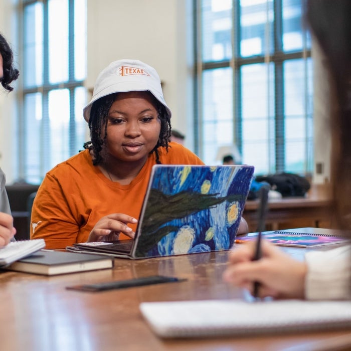 Students collaborate in a campus setting at UT Austin