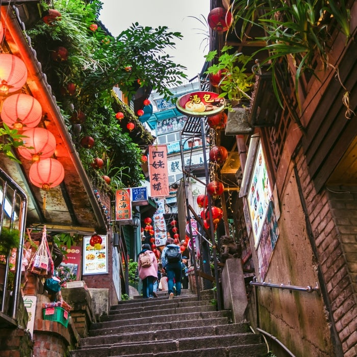 Looking up stairs in Asia line with red lanterns