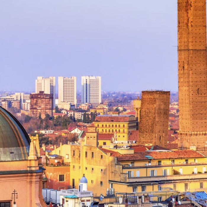 Historic buildings and church steeple in Bologna, Italy during the evening