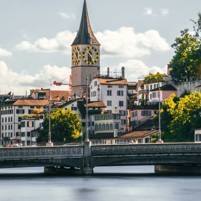 A beautiful view of the river and the historic buildings that line the city of Zurich, Switzerland