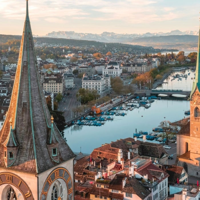 beautiful drone view in the morning of the historic buildings that line the river that runs through Zurich, Switzerland