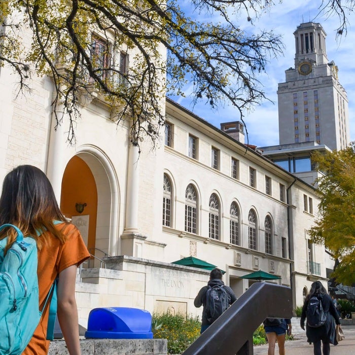 Students walking across campus on the West Mall with the UT Tower in view
