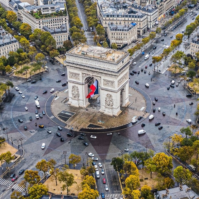 The famouse Arc de Triomphe stands proudly at the center of Place Charles de Gaulle, where 12 radiating avenuse converge in Paris, France