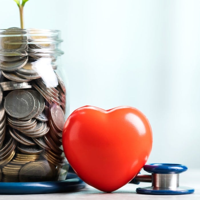 Money is a jar with a plant growing out it, beside it is a heart and stethoscope