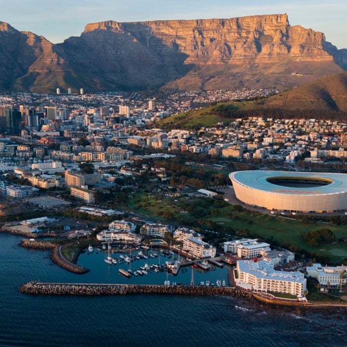 Aerial of Cape Town South Africa in the evening, mountains in the background tower above the city