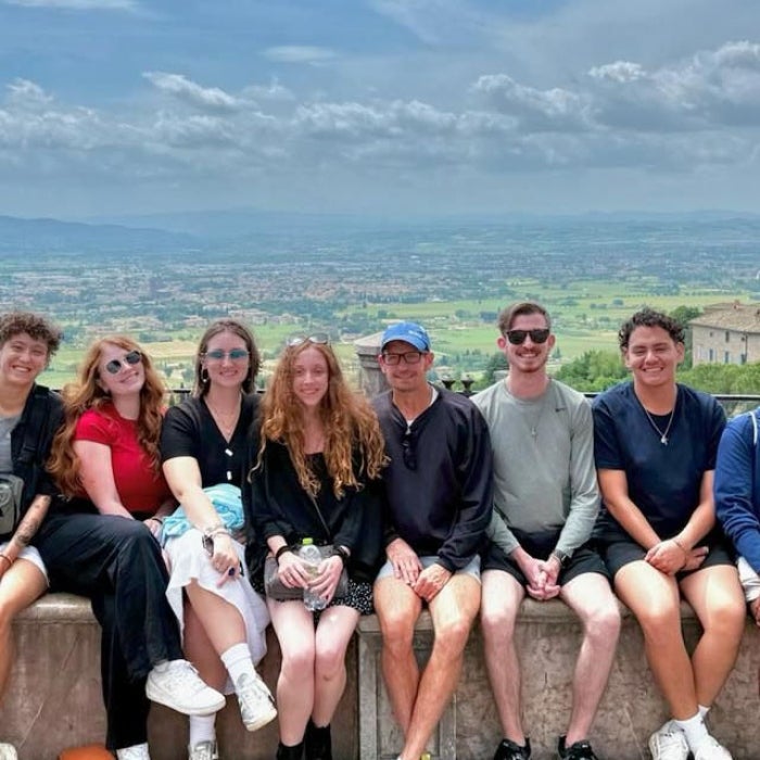 Students studying abroad in Italy pose for a group photo