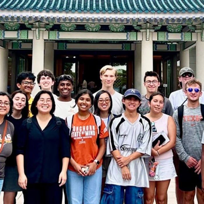 Study abroad smile for a group photo with Asian architecture in the background