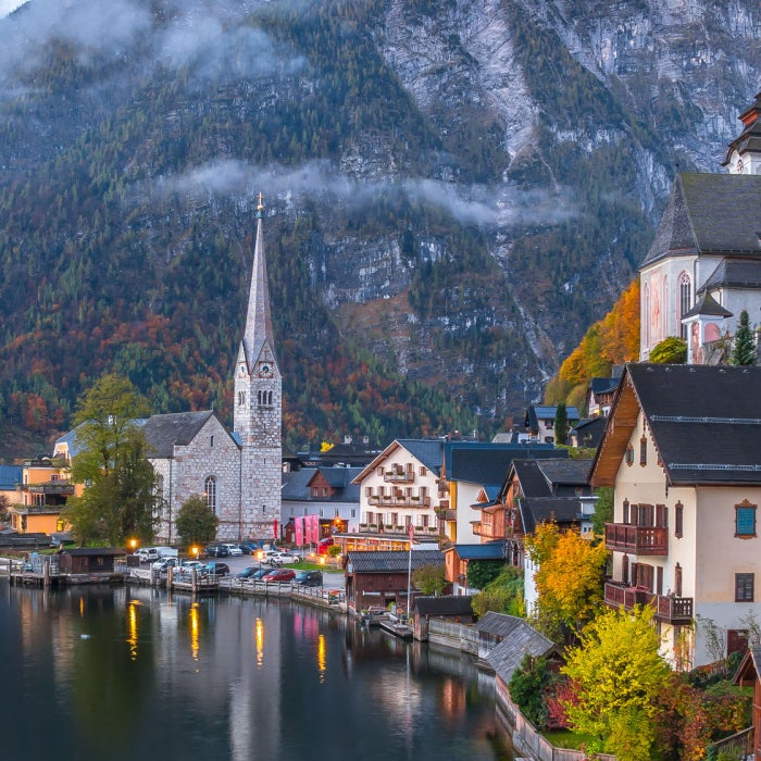 Scenic view of the famous historic Hallstatt mountain village in the Austrian Alps at twilight during blue hour at dawn in fall