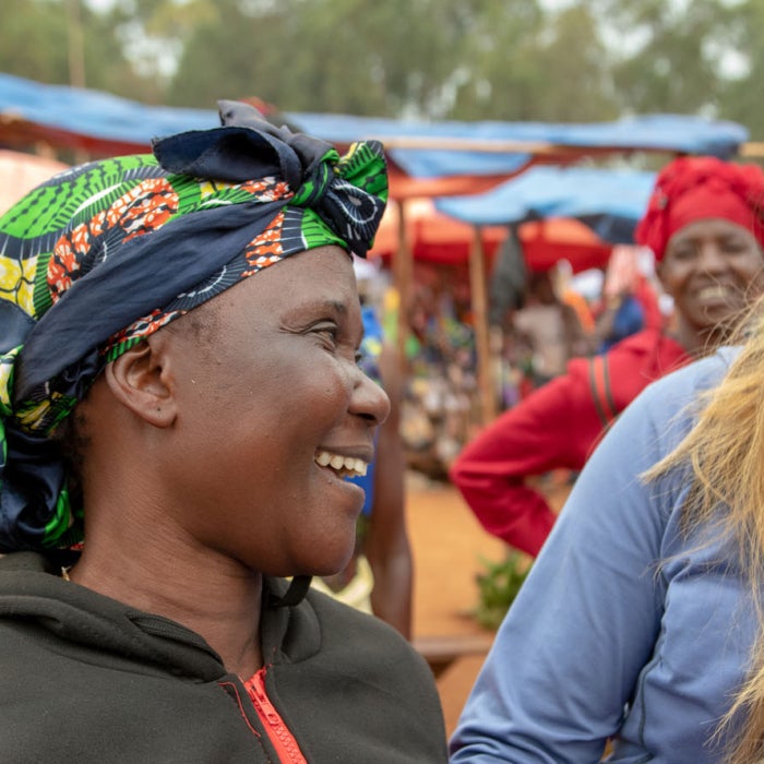 A young woman shares a smile with other local indigenous women in Tanzania, Africa