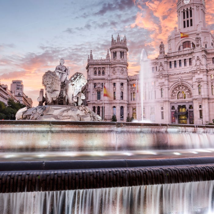 Sunset in Madrid, Spain at the Communication Palace and Cibeles Plaza.