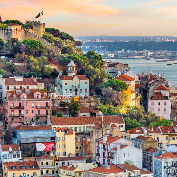 Lisbon, Portugal skyline with the Sao Jorge Castle at sunset rising above the city
