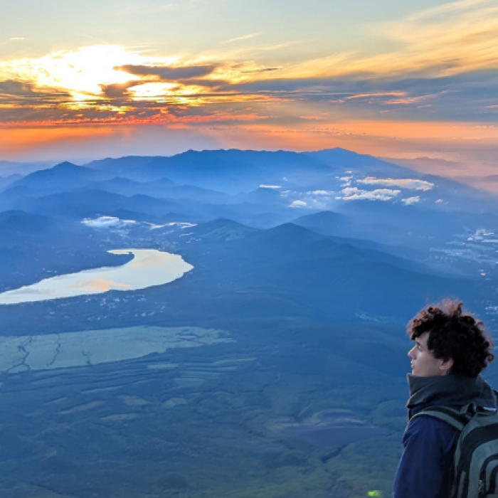 student hiker overlooking expansive mountains in Korea
