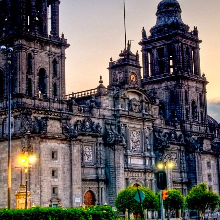 The Metropolitan Cathedral stands tall above Constitution Plaza at sunset in Mexico City, Mexico