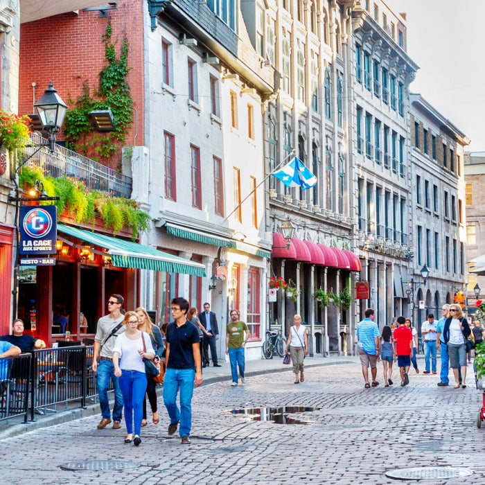 People meander at the junction of Rue Saint-Paul and Rue Saint-Vincent in the Old Montreal section of Montreal, which are famous for restaurants and unique shops