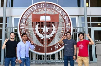 Group of students from Mexico pose in front of UT logo