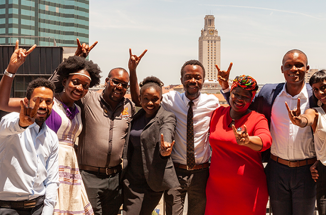 6th cohort of the Mandela Washington Fellowship pose for a photo with skyline behind them 
