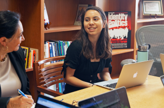 a diplomacy lab student talks with olga cabello henry during a meeting