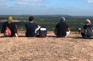 six visiting egyptian faculty sit on enchanted rock in austin