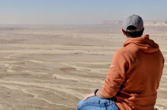 UT student is photographed staring at large dessert field 