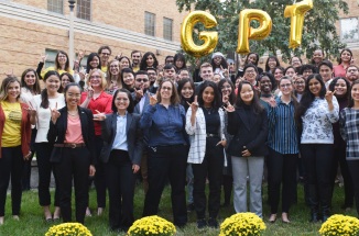 participants in GPT asia 2019 hold up a hook em and pose on campus 