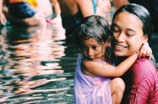 a mother and child in a river in india