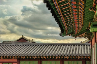 brown and green pagoda during daytime with cloudy sky