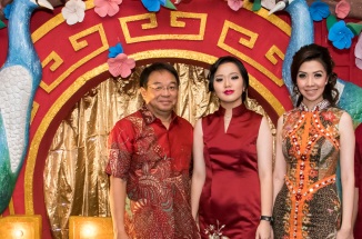 vira poses with her family in indonesia wearing traditional dresses