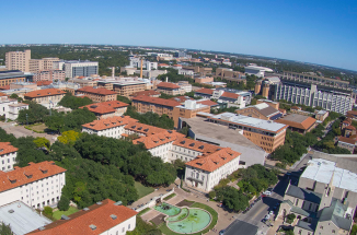 An aerial view of the UT tower and surrounding campus on a sunny day.