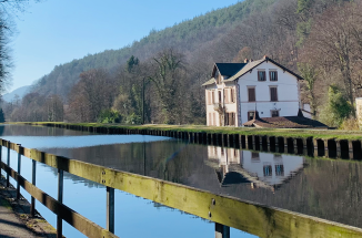 A serene cottage on a river in Saverne, France.