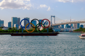 a view of tokyo by the bay with the olympic rings in the foreground