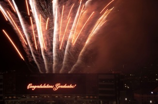 Fireworks erupt from Darrel K Royal Stadium for UT Austin's commencement ceremony