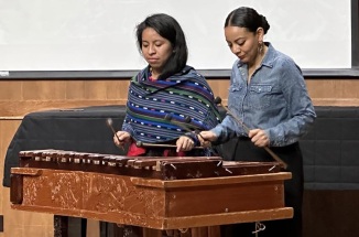 Guatemalan musician Sara Curruchich and her UT host play a marimba