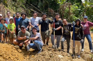 SABIC Foundation Year students smile while posing in front of a volunteer site in Puerto Rico