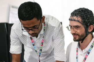 Researchers Alawieh Hussein and Kumar Satyam test brain-hand interface equipment at FILUNI 2023