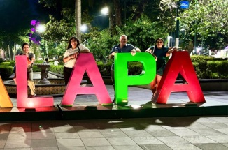 Students pose in front of city sign in Xalapa, Mexico