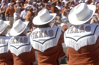 5 trumpeters from Longhorn Band show off their fringe and hats