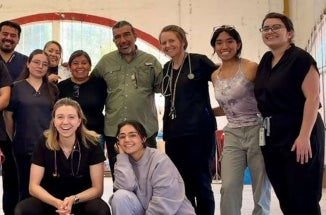 Medical students pose for a group photo at a conference.