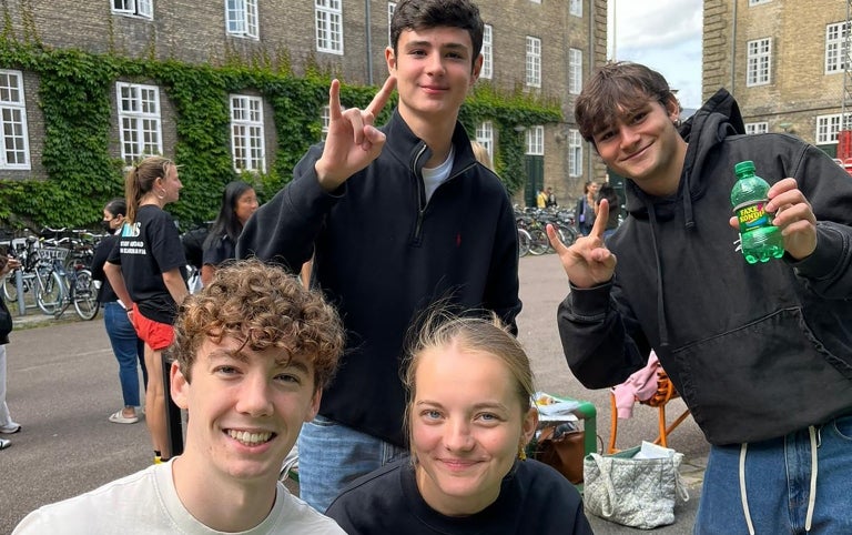 Students smile while showing the Longhorn Pride in while studying in Denmark